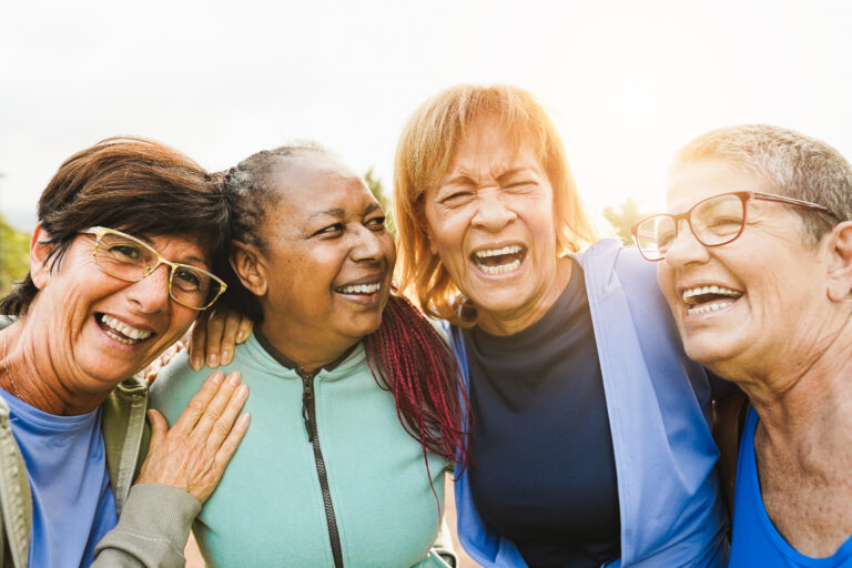 Multiracial senior women having fun together after sport workout outdoor - Healthy lifestye and mature people concept - Main focus on center women faces