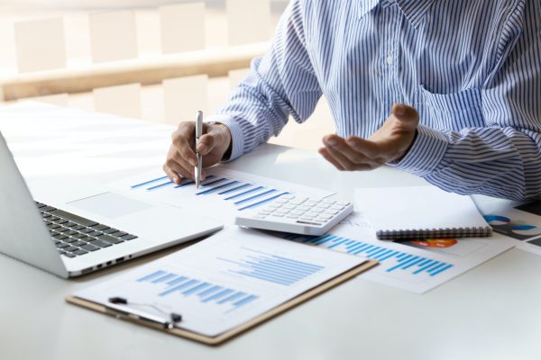 A businessman that operates on the table being checking data.